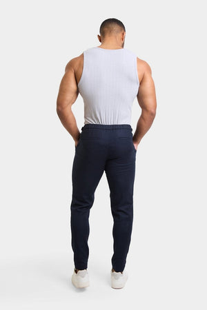 Linen Blend Cropped Pleated Trousers in Navy - TAILORED ATHLETE - ROW