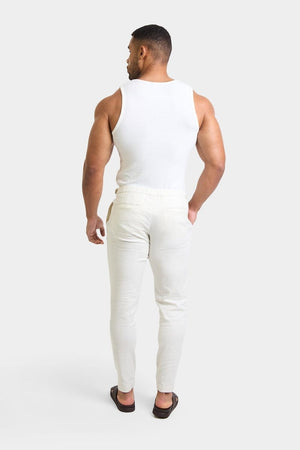 Linen Blend Cropped Pleated Trousers in Chalk - TAILORED ATHLETE - ROW