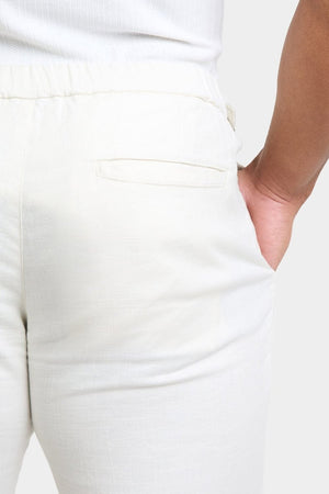 Linen Blend Cropped Pleated Trousers in Chalk - TAILORED ATHLETE - ROW